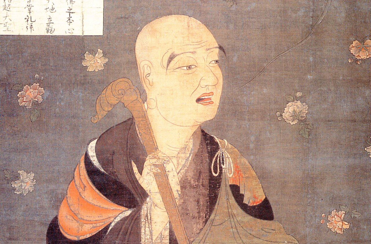 Painting of an elderly bald monk in brown and orange robes, holding a staff, against a background of scattered flowers